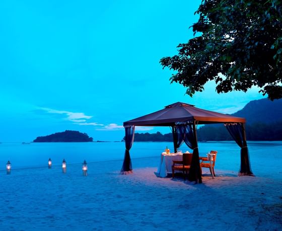 romantic beach dinner set up at The Danna Langkawi