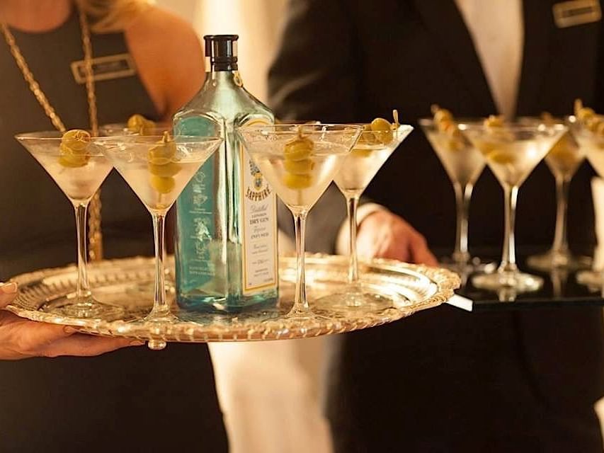 Close-up of waiters holding welcome drinks at The Mayo Hotel