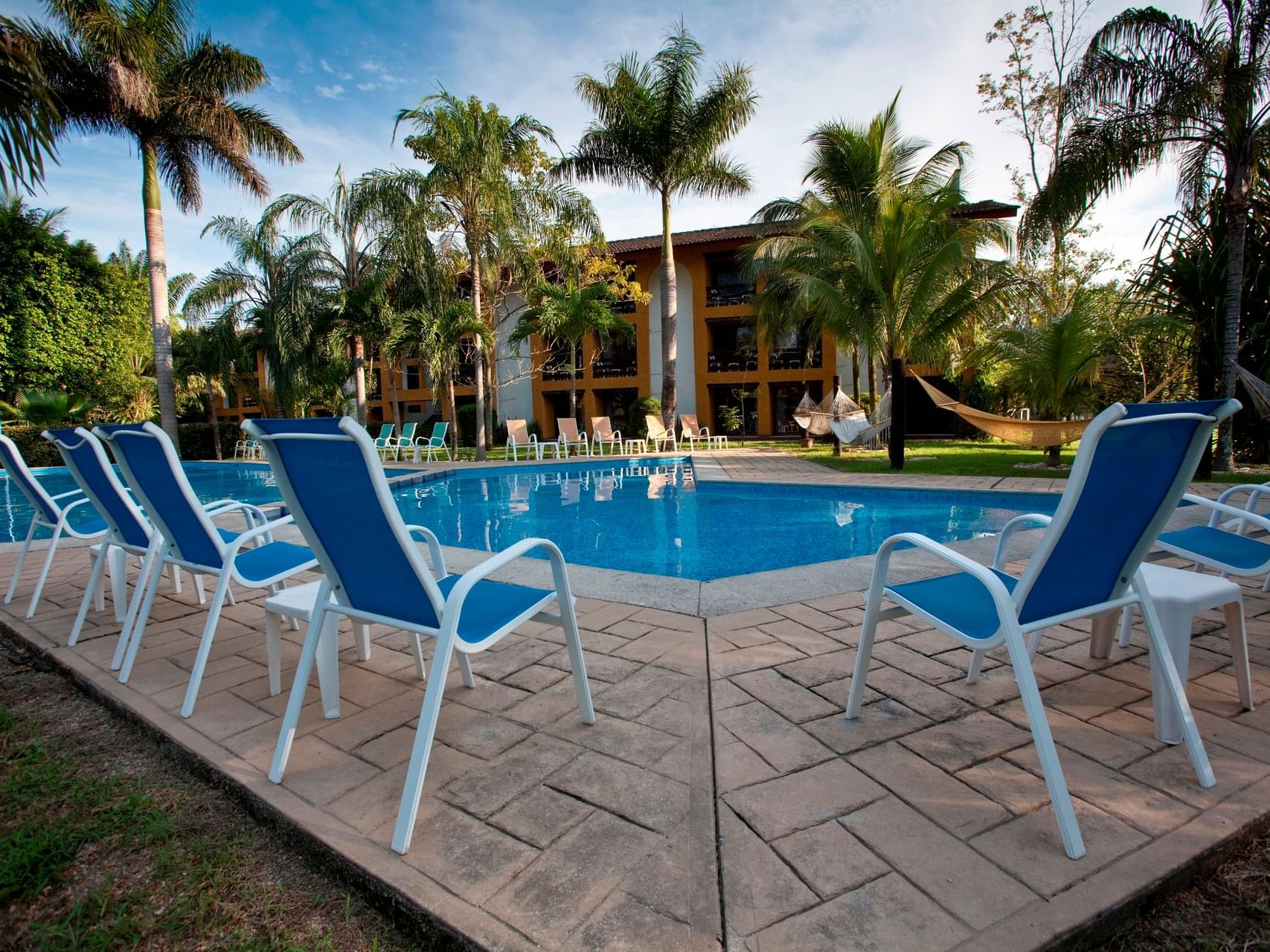 Sunbeds by the outdoor pool at Ciudad Real Palenque