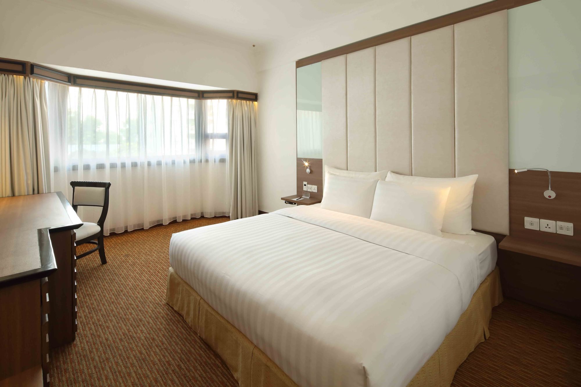 Interior of Deluxe City View King with a panoramic window at Sunway Hotel Hanoi
