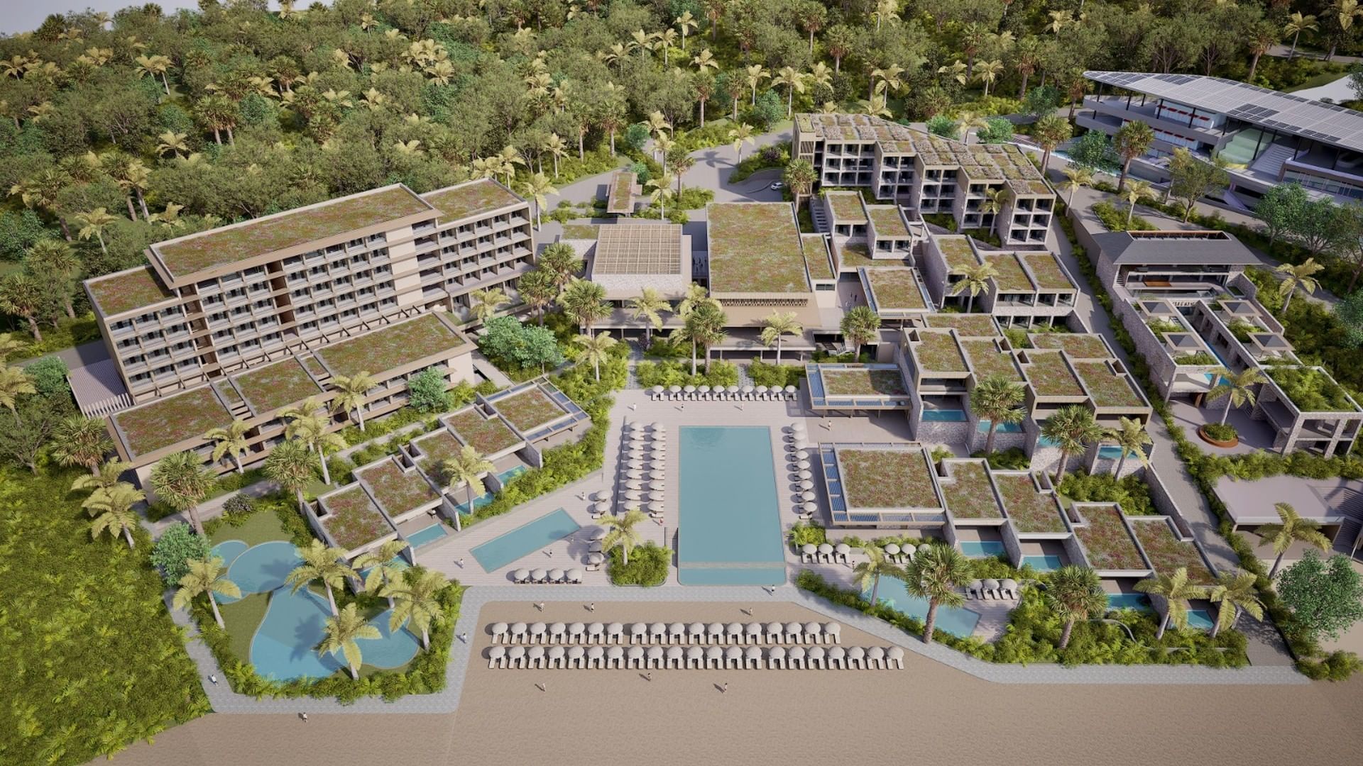 Aerial view of A'ila Resorts, Villas, & Residences, featuring multiple buildings, lush green roofs, and private pools