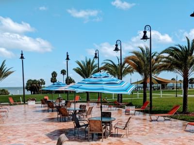 Outdoor dining area with sun beds at Safety Harbor & Resort
