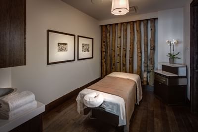 Silver Aspen Spa massage room with warm ambiance at Stein Eriksen Residences