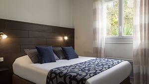 Room interior with a Classic Double bed at Hotel du Chateau