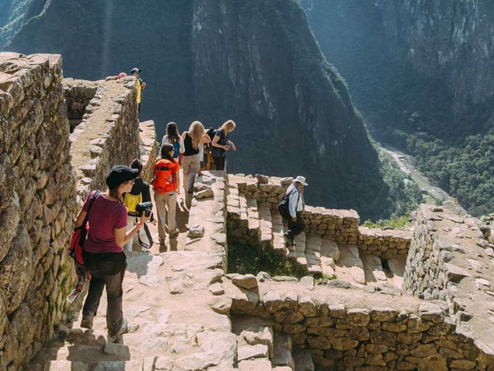 Tourists exploring Machu Picchu Citadel near Hotel Sumaq 