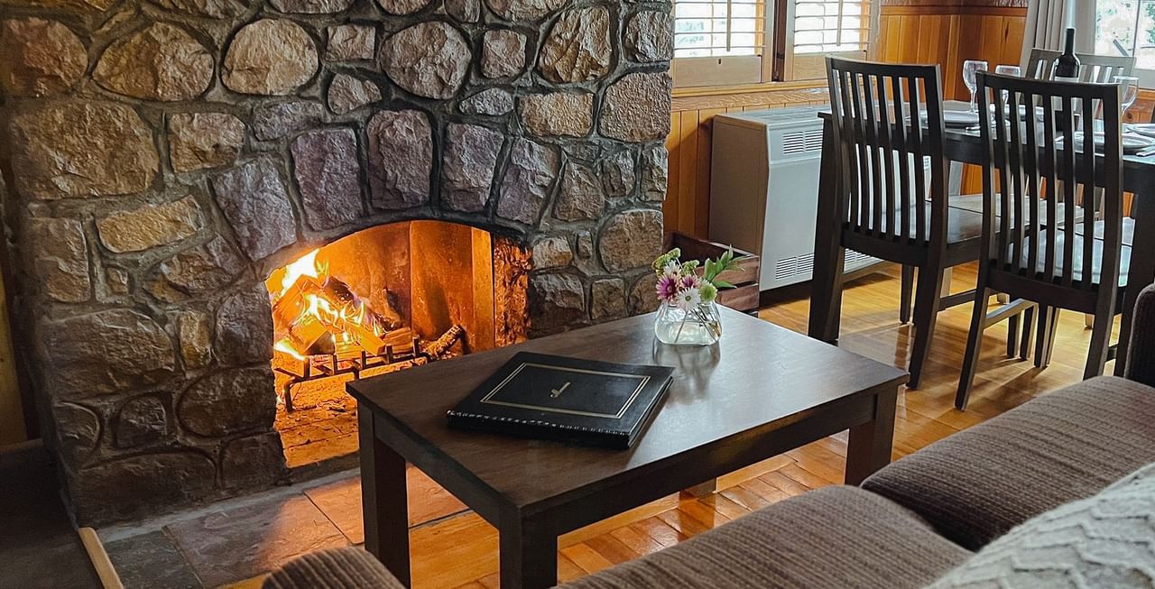 Couch, table, dining area, and fireplace
