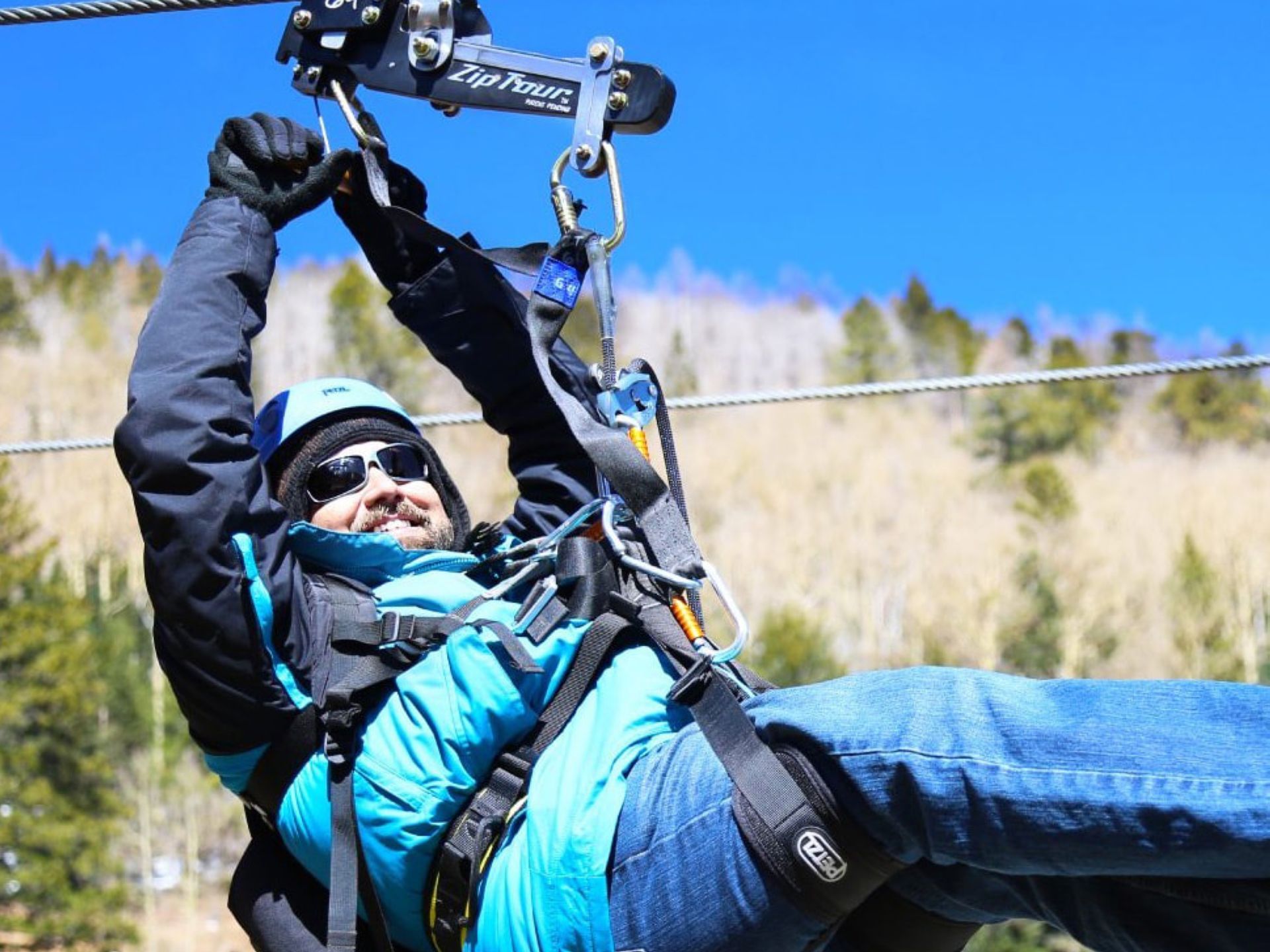 Man experiencing a zipline near Elegante Lodge & Resort Ruidoso