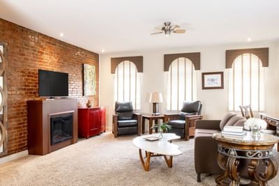 TV & living area with comfy chairs  in a Residence at Retro Suites Hotel