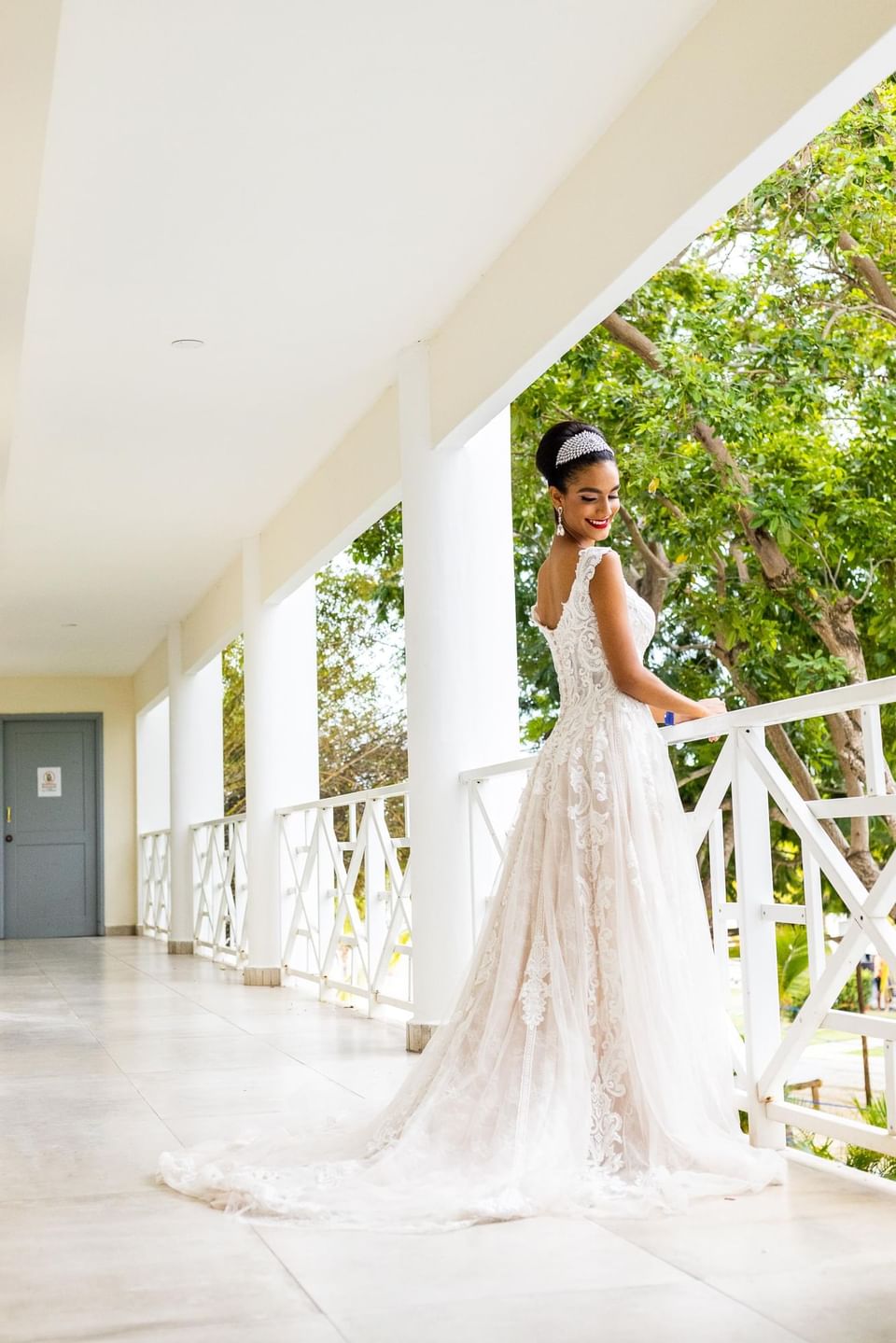 Bride posing on the balcony at Playa Blanca Beach Resort