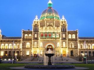 Exterior view of BC Parliament Buildings at night near Pendray Inn & Tea House