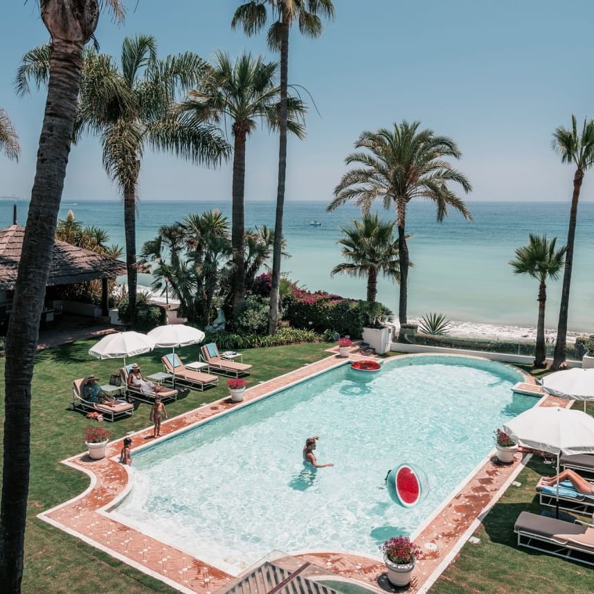Outdoor pool area by the ocean at Marbella Club Hotel