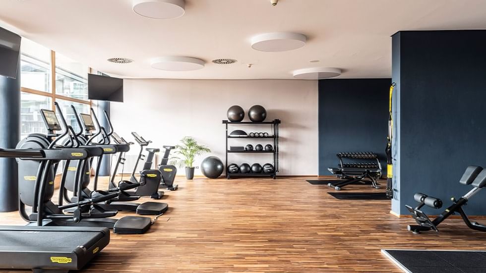 Gym with exercise equipment with wooden floors at Falkensteiner Balance Resort Stegersbach