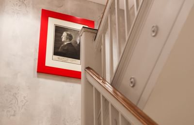 Stair railing with a picture on a wall at The Eliot Hotel