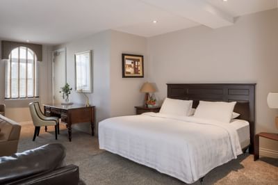 Cozy bed, nightstands & workspace in Executive Residences 201 at Retro Suites Hotel