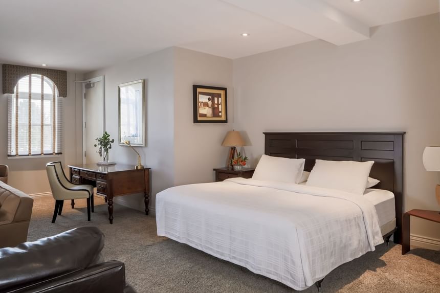 Cozy bed, nightstands & workspace in Executive Residences 201 at Retro Suites Hotel