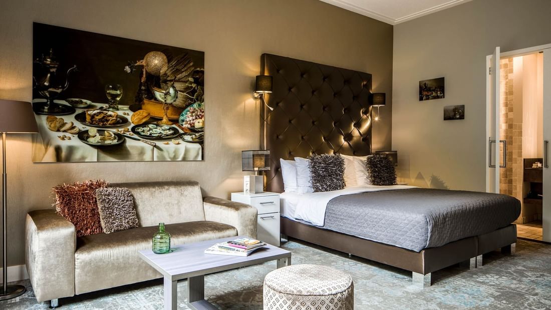 Cozy bed with sofa in Luxury Suites with Patio at Luxury Suites Amsterdam
