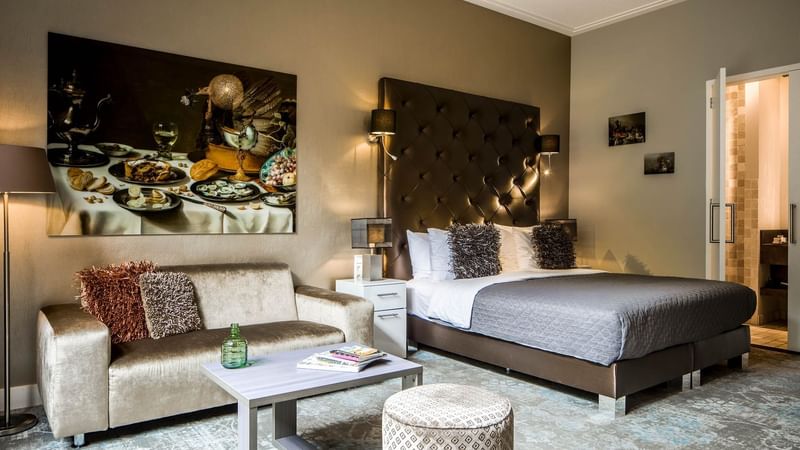 Cozy bed with sofa in Luxury Suites with Patio at Luxury Suites Amsterdam