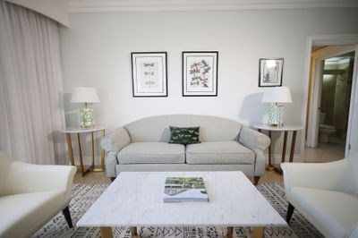 Spacious living area with cozy couches in One Bedroom Suite at Courtleigh Hotel & Suites