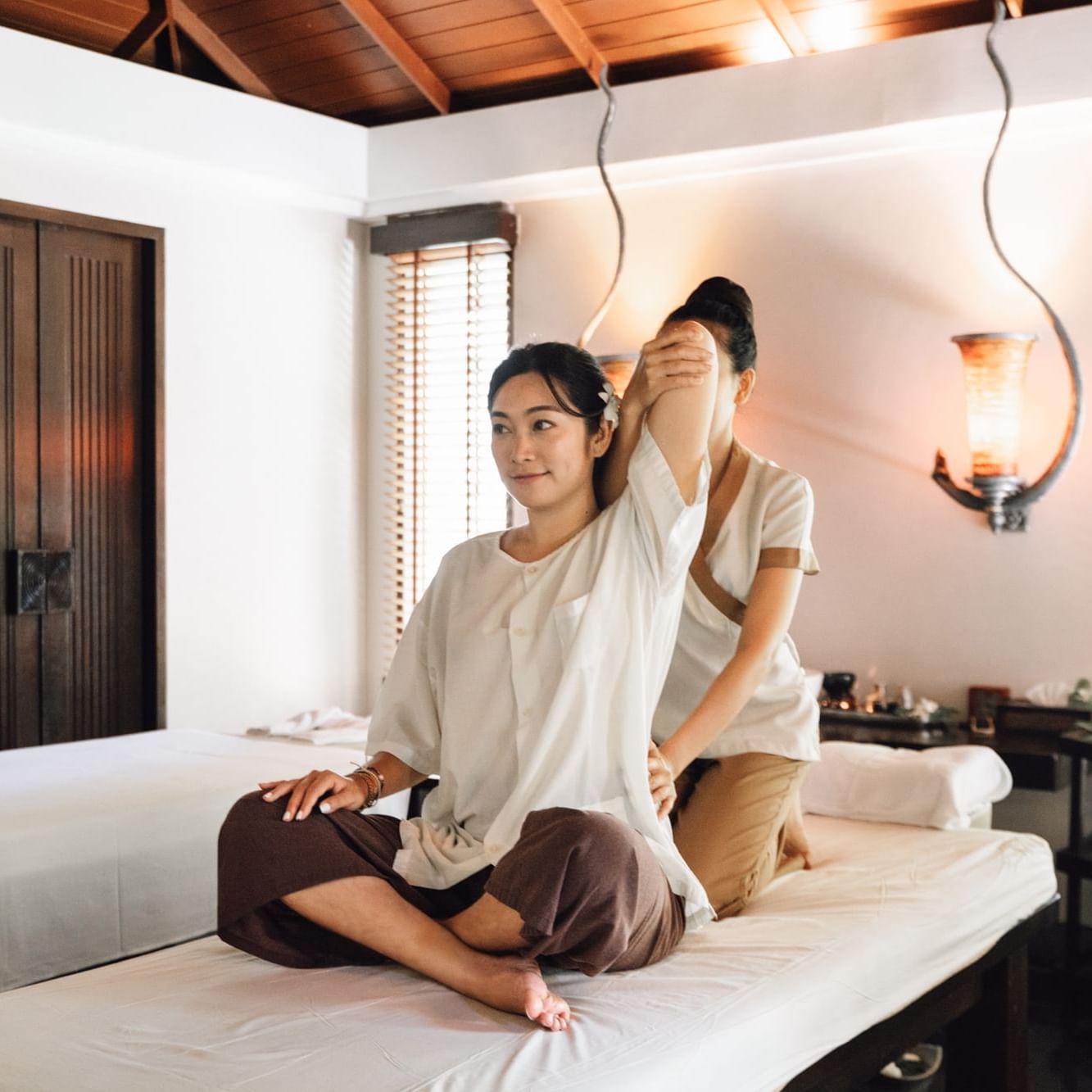 Woman receiving a relaxing Thai massage in a serene spa setting