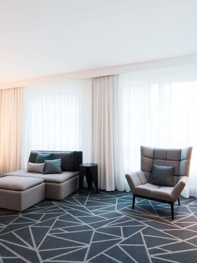 Premium loft Suite with a couch and a cabinet near window at Warwick Le Crystal Montreal