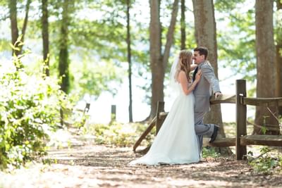 bride and groom kissing in woods