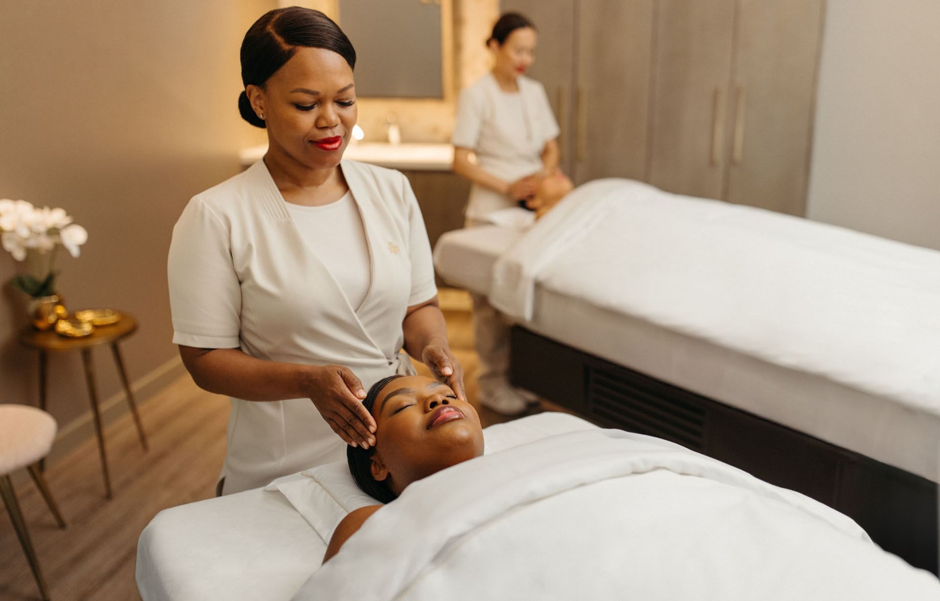 Guerlain Spa with two therapists preparing for treatments by massage beds at Hotel X Toronto
