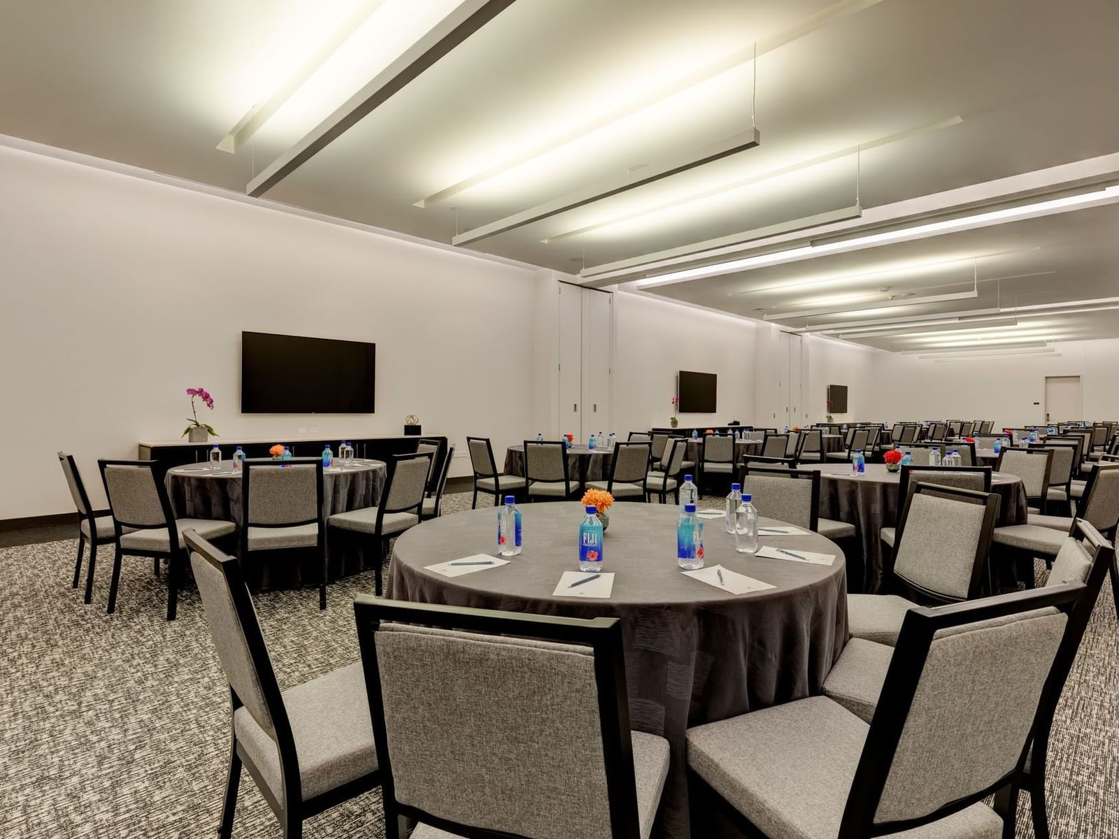 Toronto X Coronation Park with banquet table set up and TVs on the wall at Hotel X Toronto