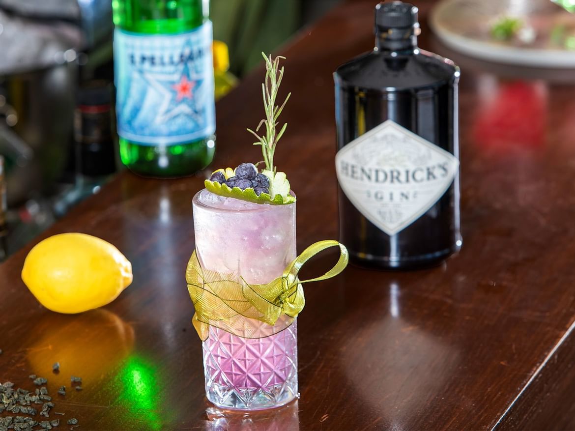 Cocktail glass & bottles on a table in Coco Bar at Senses Hotel