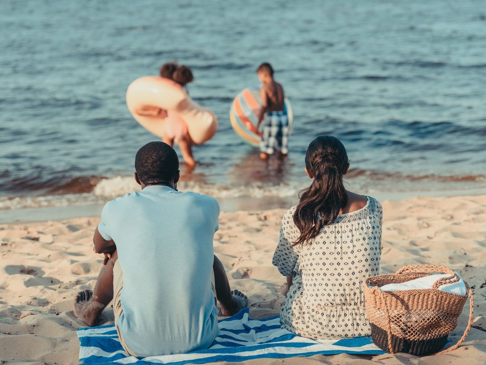 Parents watching their kids at the beach at ICONA Windrift