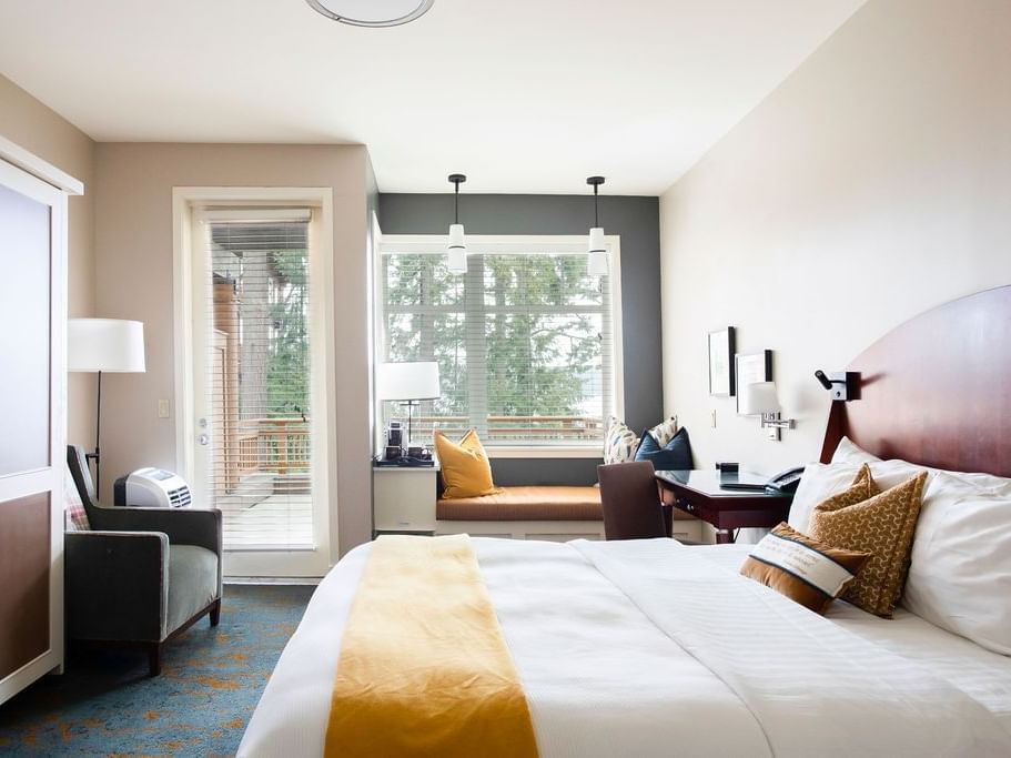 King-size bed, work desk, and cozy couch in Courtyard King ADA at Alderbrook Resort & Spa