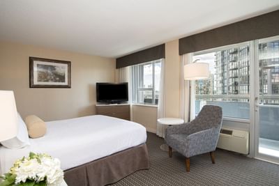 Bed in hotel room with city view