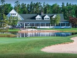 Panoramic view of the front exterior of Charlevoix Country Club near The Earl