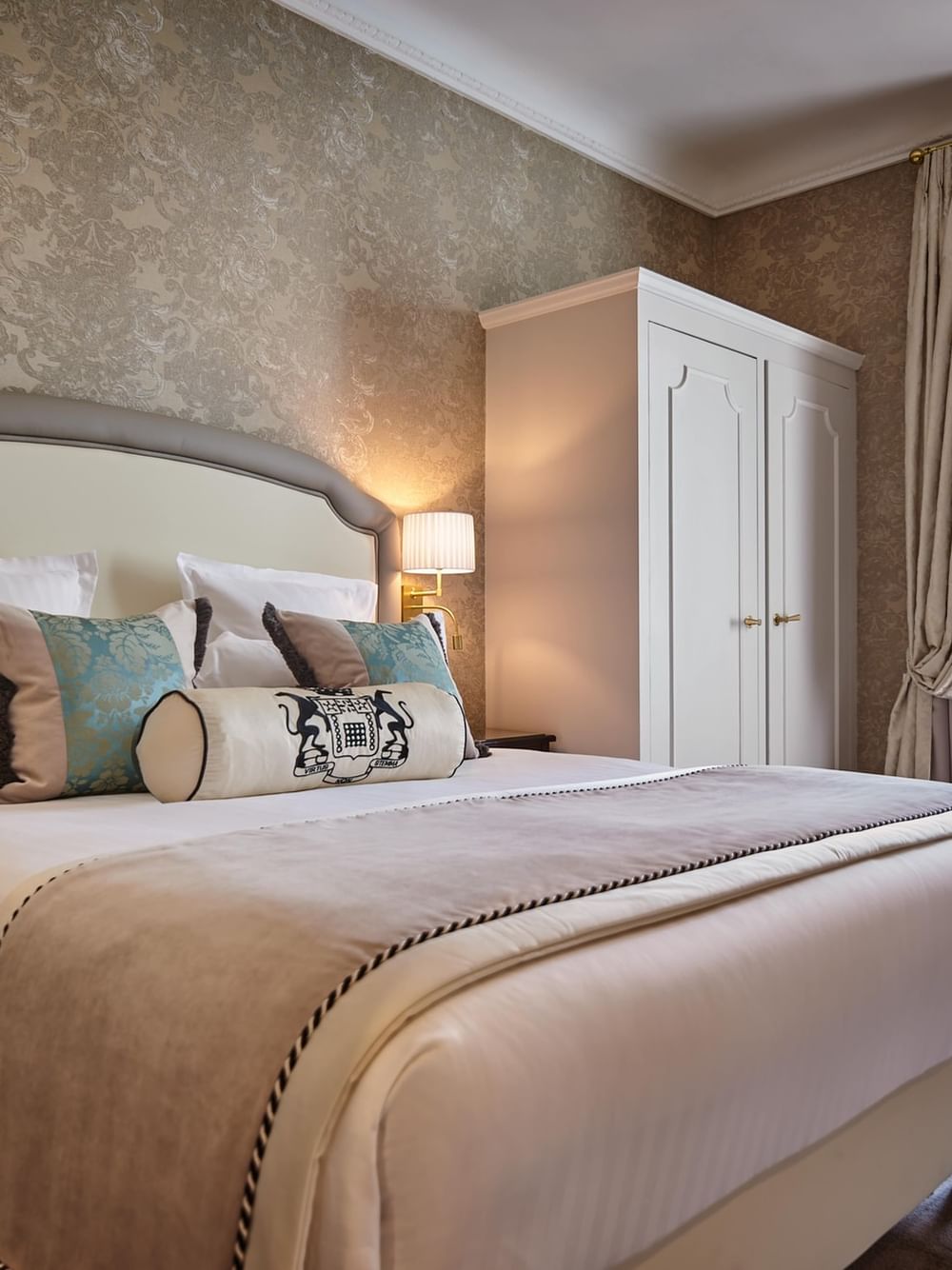 Bed with white cupboard near window in Executive Room at Hotel Westminster Paris