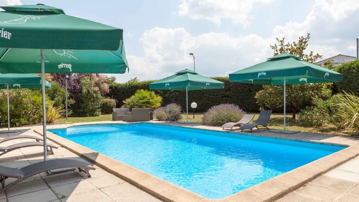 Outdoor swimming pool with sunbeds at Hotel du Phare