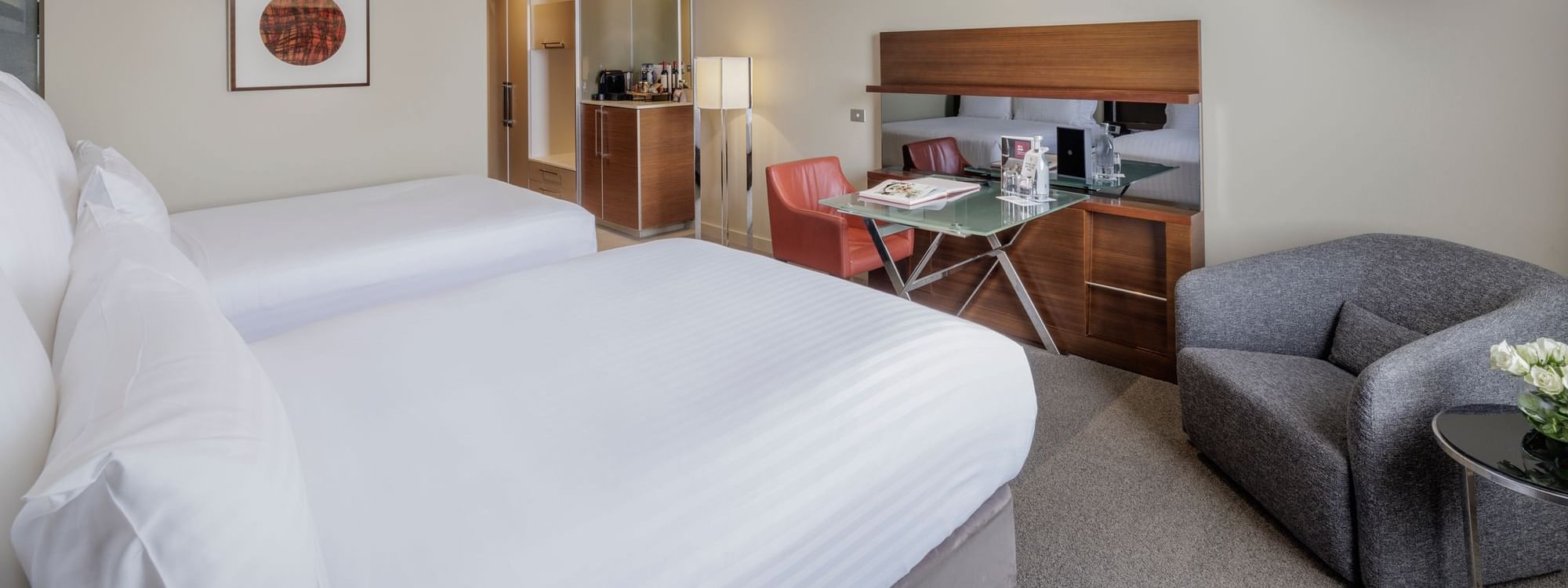 Wall-mounted TV with work desk facing two beds in Deluxe Room - Two Double bed at Pullman Sydney Olympic Park