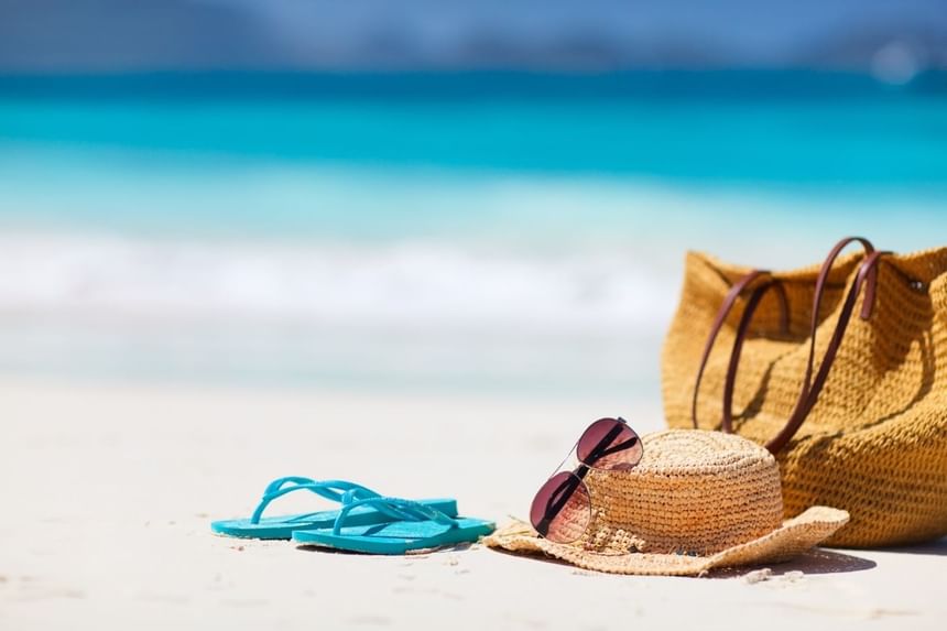 Slippers,hat, bag and sun glasses on the beach at Condado Plaza