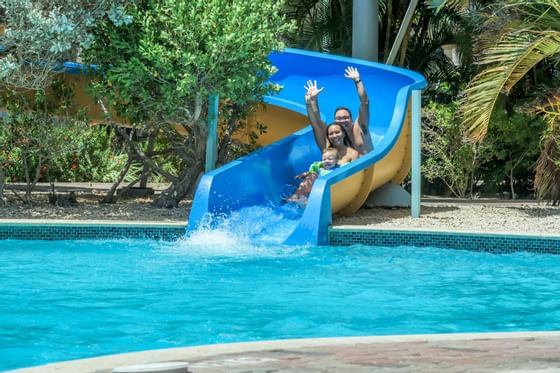 A family sliding down the water slide at Eagle Aruba Resort