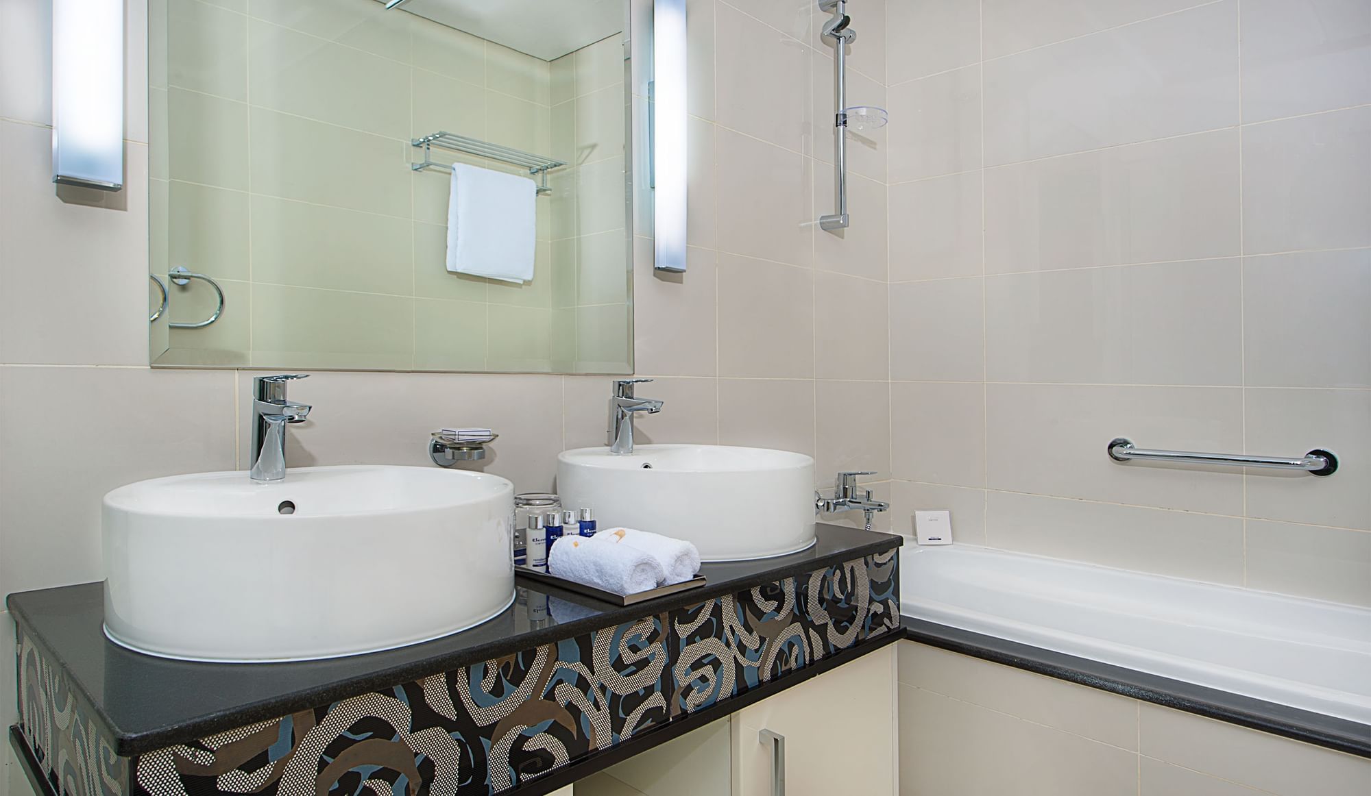 Bathroom with dual sinks and bathtub in One Bedroom Suite, hotel rooms in Dubai at DAMAC Maison Mall Street
