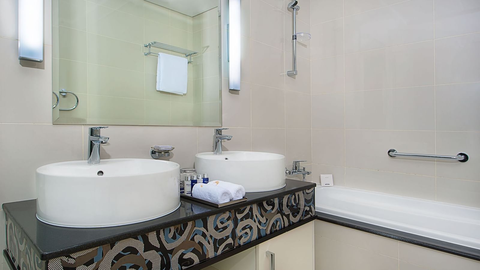 Bathroom interior with dual sinks and bathtub in a room at DAMAC Maison Mall Street