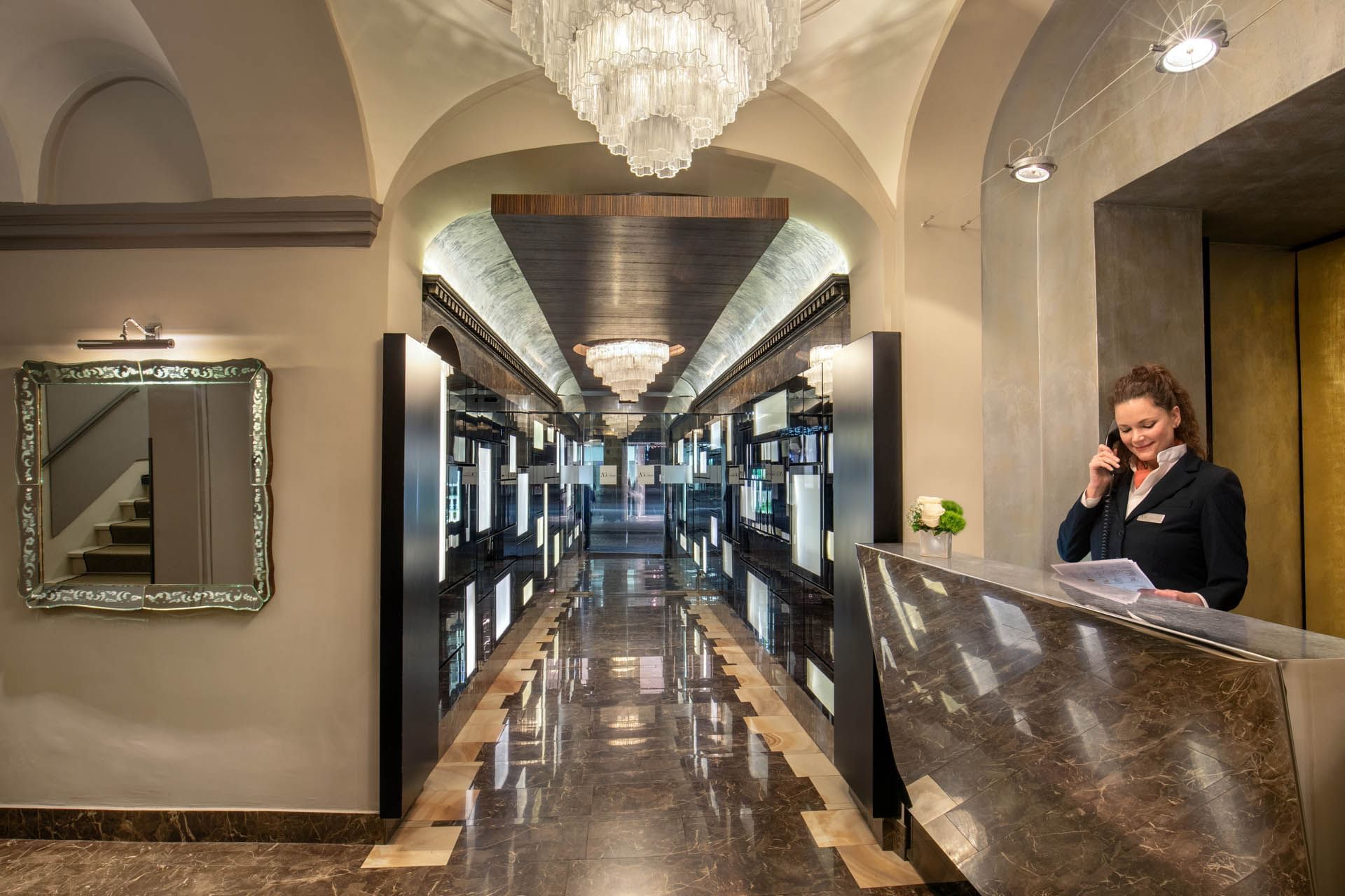 Receptionist making a call by the front desk at The Style