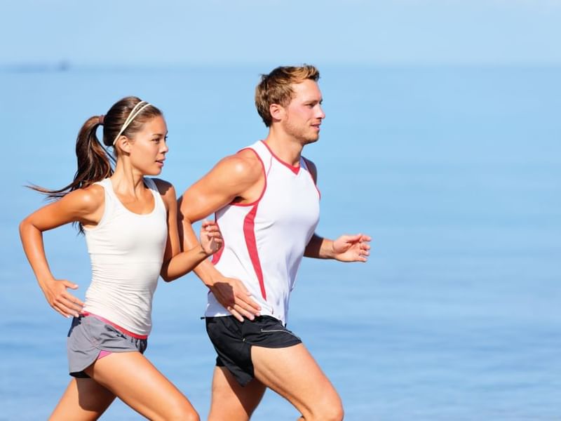 A couple running by the sea near Fiesta Americana