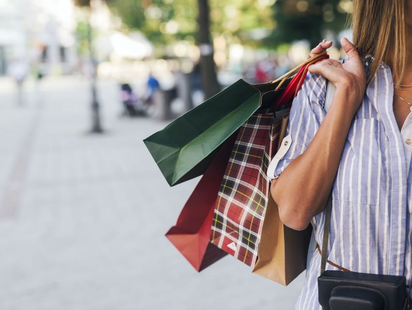 A lady carring shopping bags in different colors