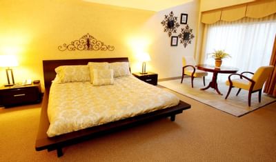 Bed with dining table in Presidential Suite at Honor’s Haven Retreat
