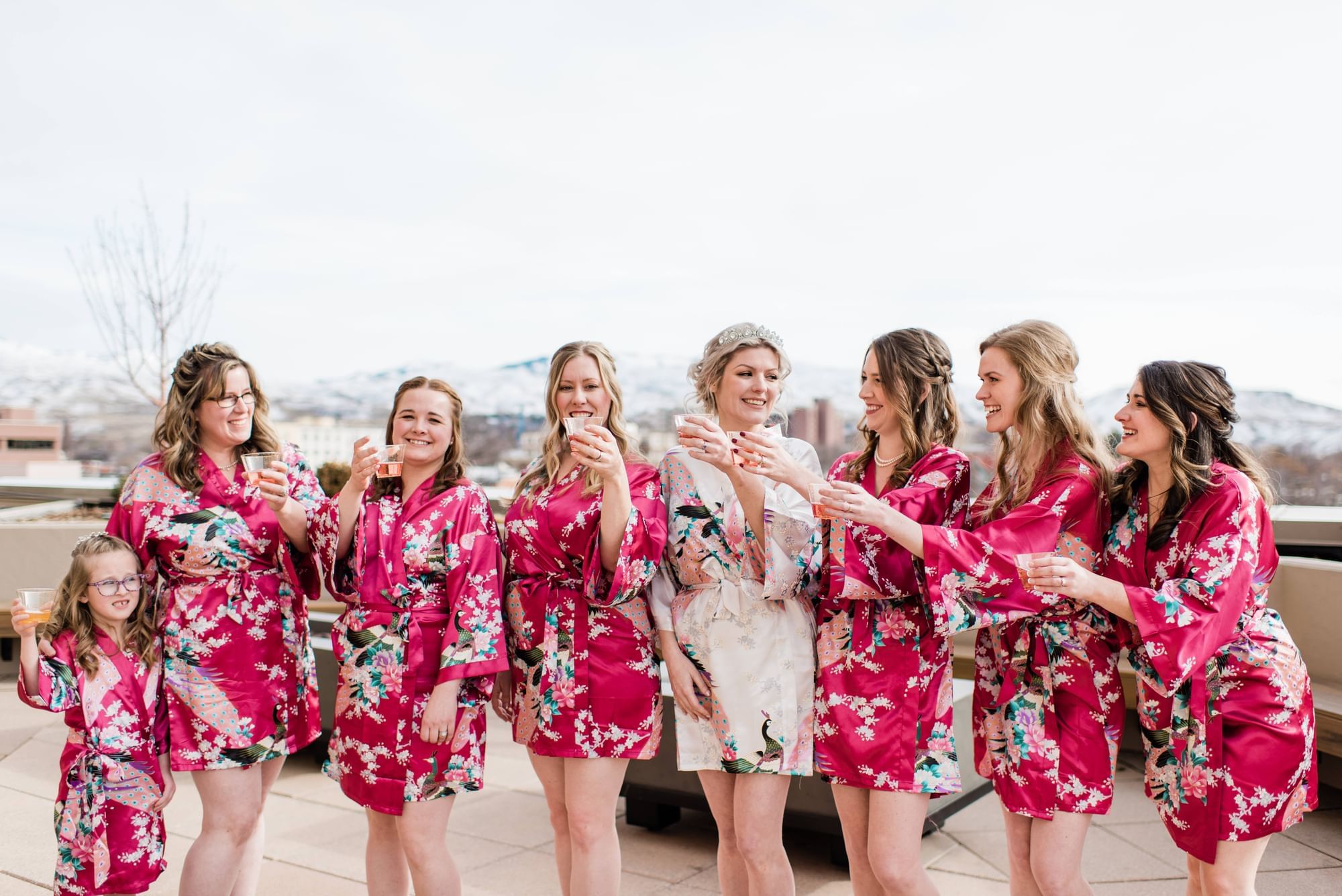 A row of bridesmaids in robes & celebrating at Grove Hotel