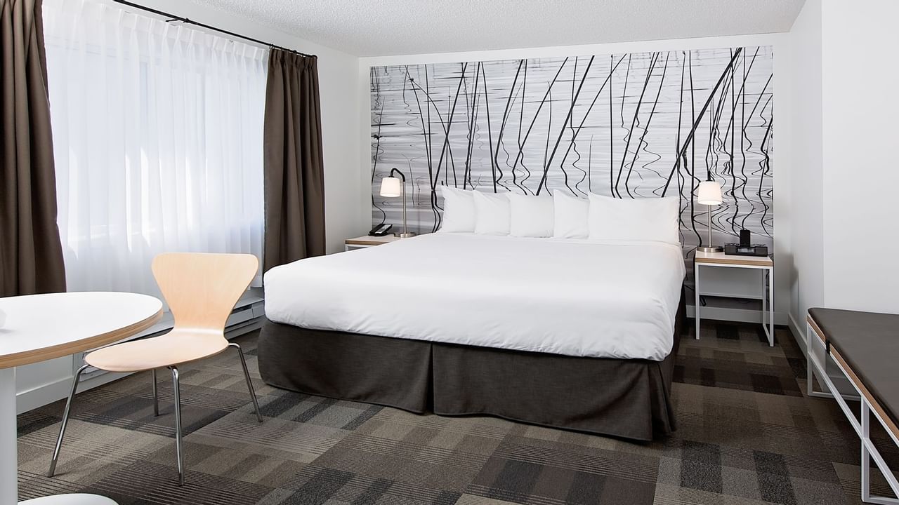 Bed in hotel room with modern artwork