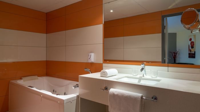 Bathroom bathtub & vanity area in a room at Actuel Hotel