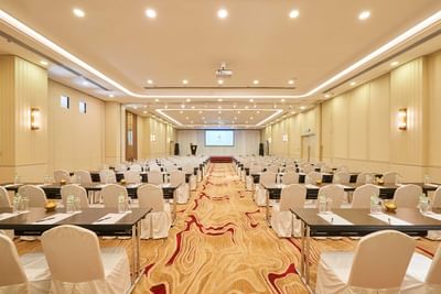 White chairs in conference set-up in a meeting room at Eastin Hotels