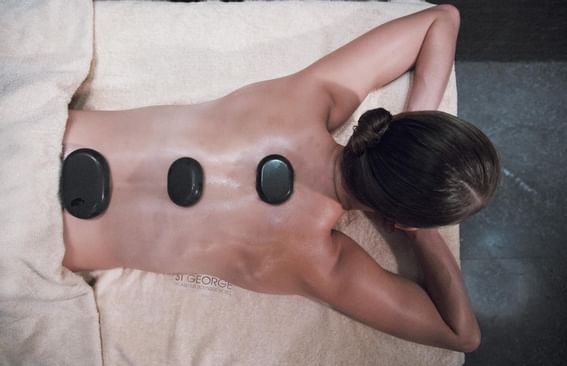 Ongoing hot stone massage in spa at St George Lycabettus