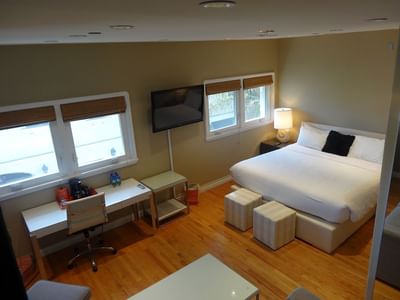 overhead view of king bedroom with flat-screen tv and desk