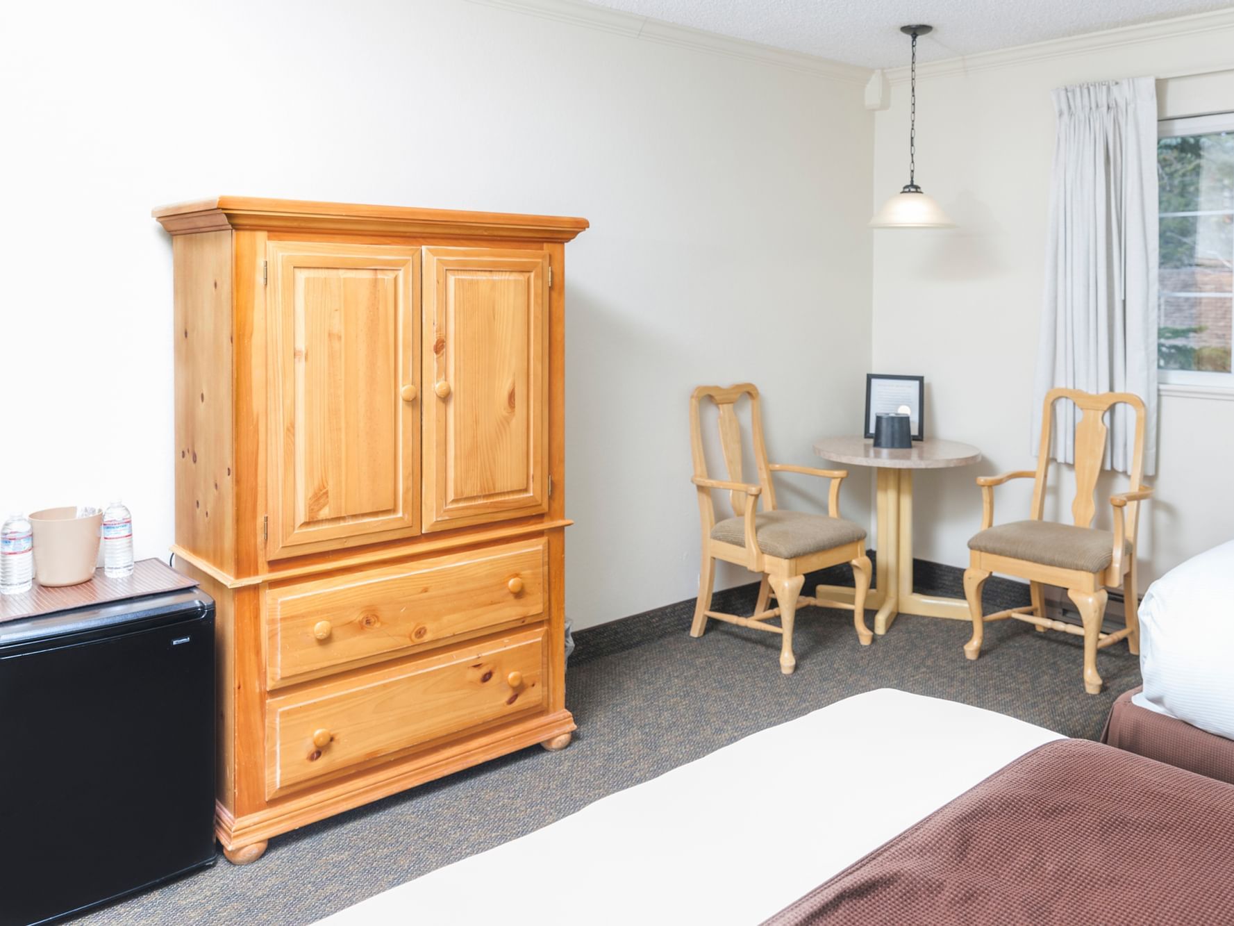 Tall dress, table and chairs in Double Room at Alpenhof Lodge